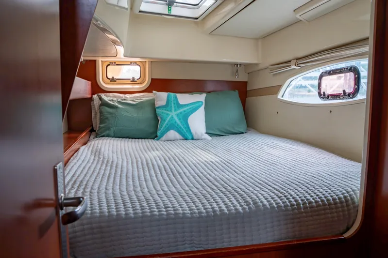 Papillon Yacht Photos Pics Cozy cabin interior of a 2012 Leopard 39 yacht with a neatly made bed.