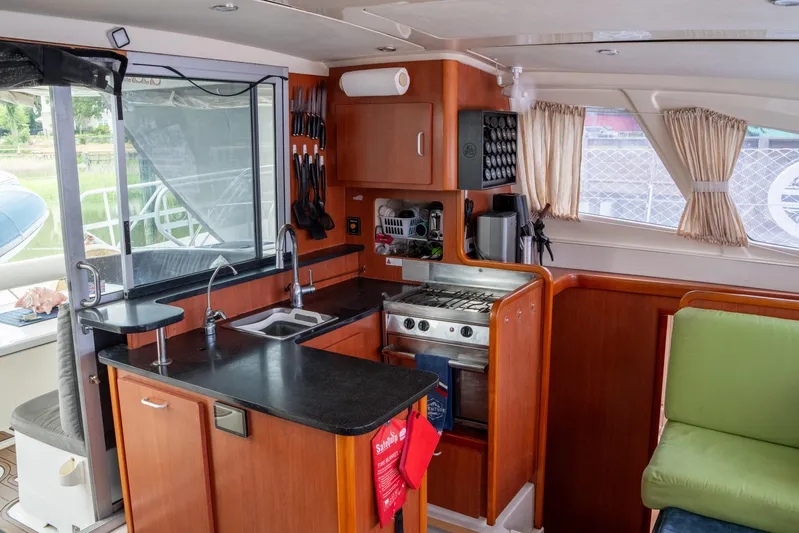 Papillon Yacht Photos Pics Interior of 2012 Leopard 39 yacht kitchen with modern amenities and wooden cabinetry.