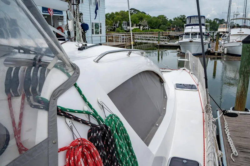 Papillon Yacht Photos Pics Sailboat docked at marina, Leopard 39 model, colorful ropes, calm water, overcast sky.