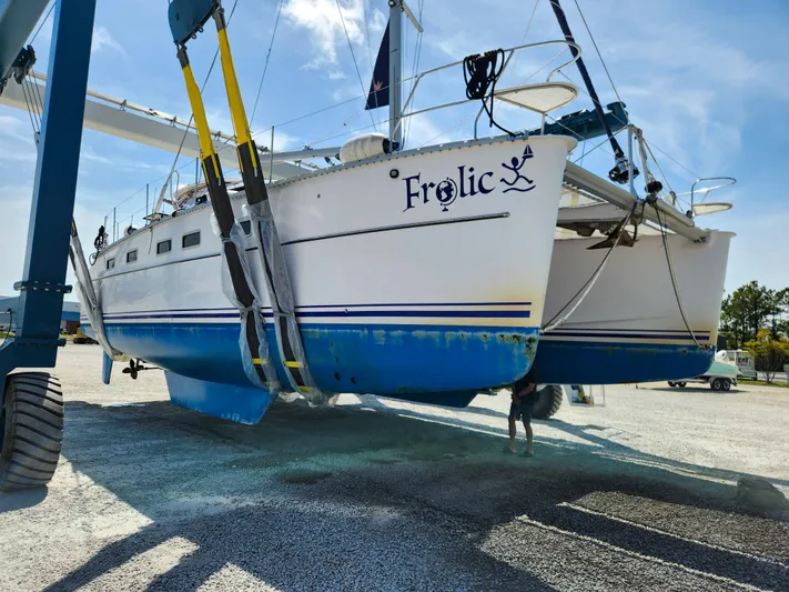 Frolic Yacht Photos Pics Antares 44i catamaran named "Frolic" being lifted, 2014 model, in a boatyard.
