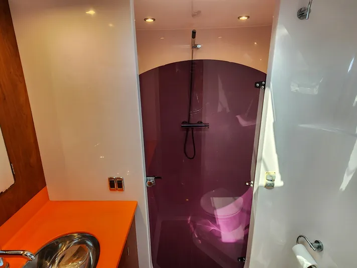 Frolic Yacht Photos Pics Modern bathroom in 2014 Antares 44i yacht with vibrant orange countertop and purple shower.