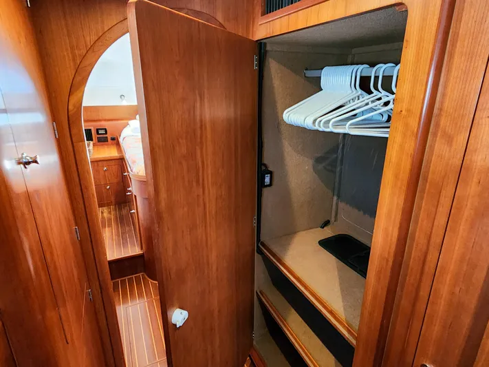 Frolic Yacht Photos Pics Wooden closet interior on 2014 Antares 44i yacht with hangers and shelves.