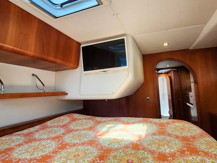 Frolic Yacht Photos Pics Luxurious Antares 44i 2014 yacht cabin with TV, skylight, and vibrant bedding.