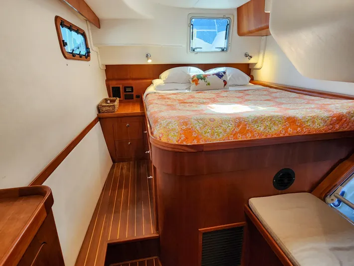 Frolic Yacht Photos Pics Cozy cabin interior of 2014 Antares 44i yacht with bed and wooden furnishings.