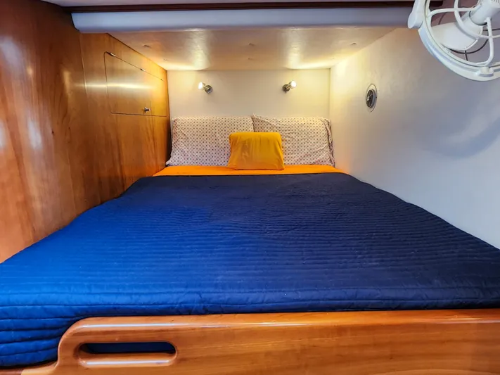 Frolic Yacht Photos Pics Cozy cabin bed in 2014 Antares 44i yacht with blue bedding and wooden accents.