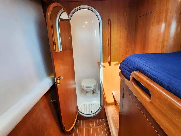 Frolic Yacht Photos Pics 2014 Antares 44i yacht interior with wooden cabin and compact bathroom.