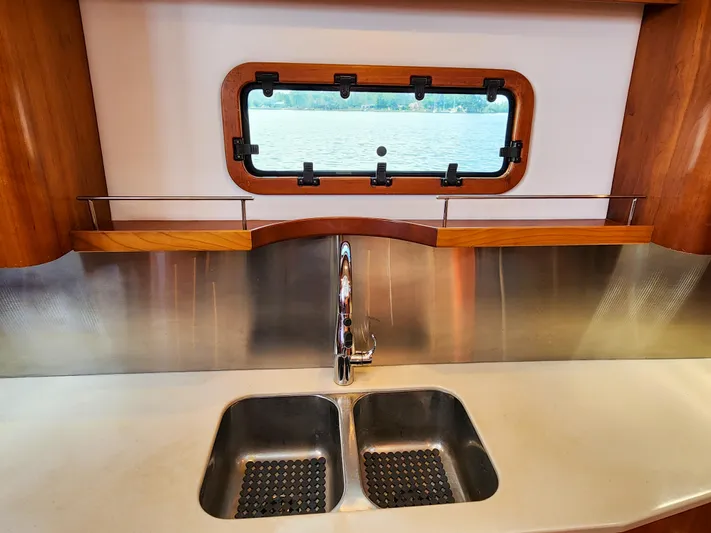 Frolic Yacht Photos Pics Modern kitchen sink on Antares 44i yacht, 2014 model, with stainless steel backsplash.