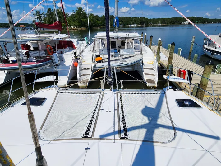 Frolic Yacht Photos Pics 2014 Antares 44i catamaran docked at a marina with clear skies.