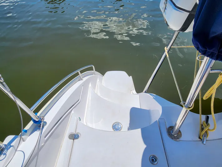 Frolic Yacht Photos Pics Antares 44i 2014 yacht stern view with water reflection and deck details.