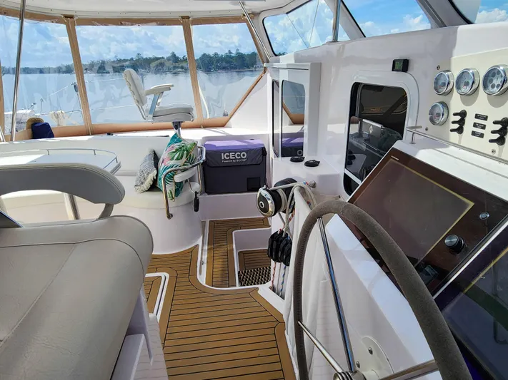 Frolic Yacht Photos Pics Luxurious 2014 Antares 44i yacht interior with steering wheel, gauges, and scenic water view.