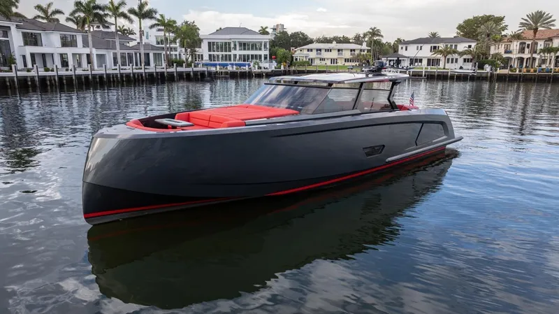 Moonshot Yacht Photos Pics 2023 Vanquish Yachts VQ58 luxury yacht on calm water near waterfront homes.