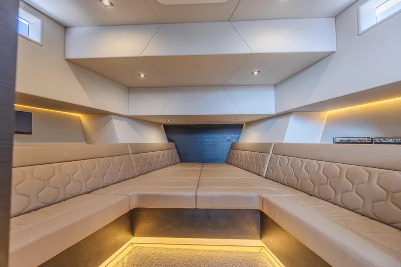 Moonshot Yacht Photos Pics Luxurious interior of 2023 Vanquish Yachts VQ58 with elegant seating and ambient lighting.