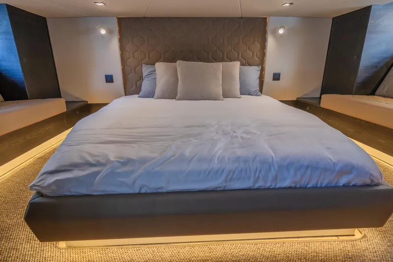 Moonshot Yacht Photos Pics Luxurious bedroom interior of 2023 Vanquish Yachts VQ58 with modern design and ambient lighting.