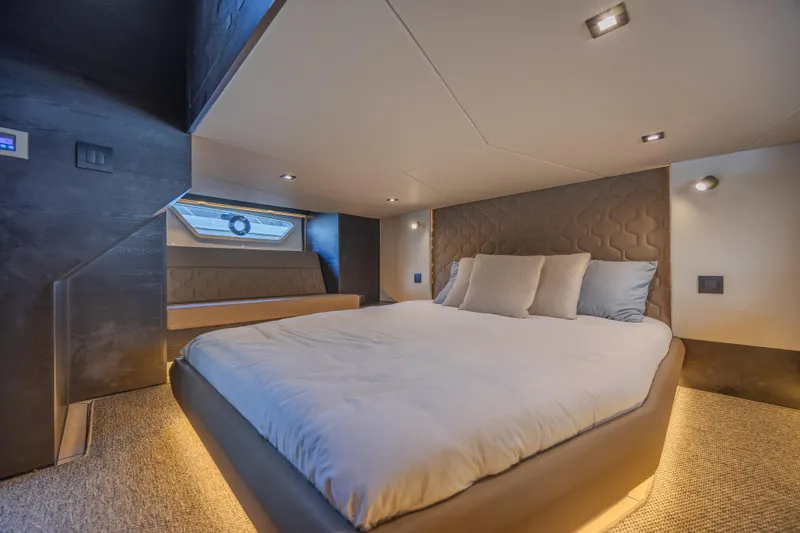 Moonshot Yacht Photos Pics Luxurious bedroom interior of 2023 Vanquish Yachts VQ58, featuring modern design and ambient lighting.