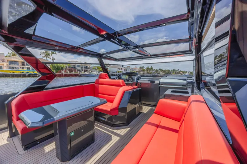 Moonshot Yacht Photos Pics Luxurious 2023 Vanquish Yachts VQ58 interior with sleek red seating and modern design.