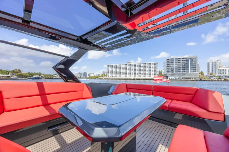 Moonshot Yacht Photos Pics Luxurious 2023 Vanquish Yachts VQ58 with red seating and sleek design on the water.