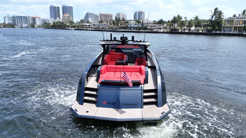 Moonshot Yacht Photos Pics 2023 Vanquish Yachts VQ58 luxury yacht cruising on a scenic waterway.