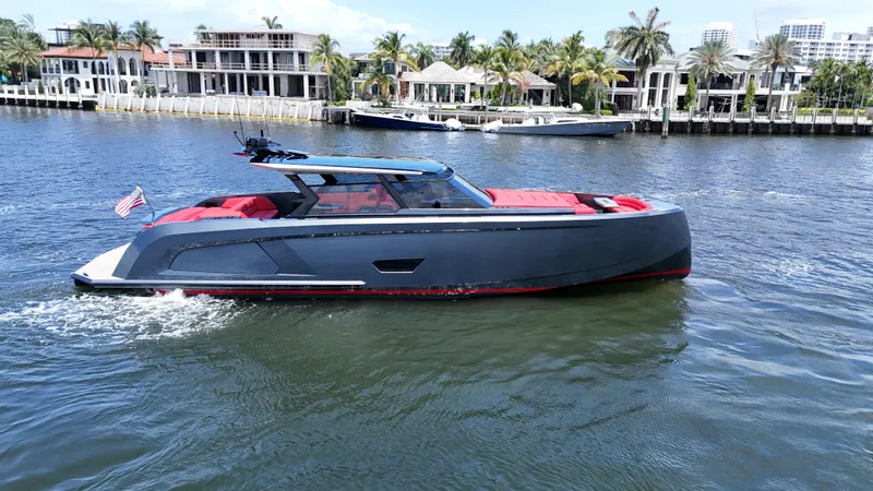 Moonshot Yacht Photos Pics 2023 Vanquish Yachts VQ58 cruising on a scenic waterfront with luxury homes.