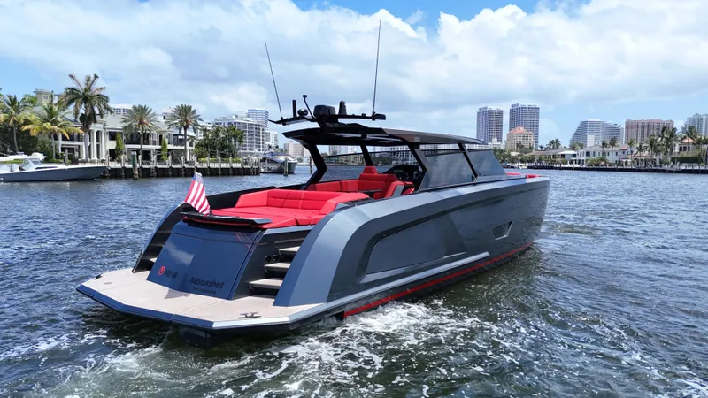 Moonshot Yacht Photos Pics 2023 Vanquish Yachts VQ58 cruising on a sunny day, featuring sleek design and vibrant red seating.