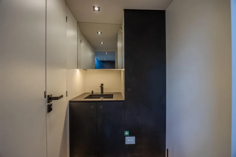 Moonshot Yacht Photos Pics Modern interior of 2023 Vanquish Yachts VQ58 with sleek sink and minimalist design.