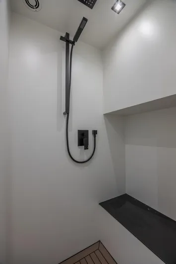 Moonshot Yacht Photos Pics Modern shower area in 2023 Vanquish Yachts VQ58, featuring sleek black fixtures.