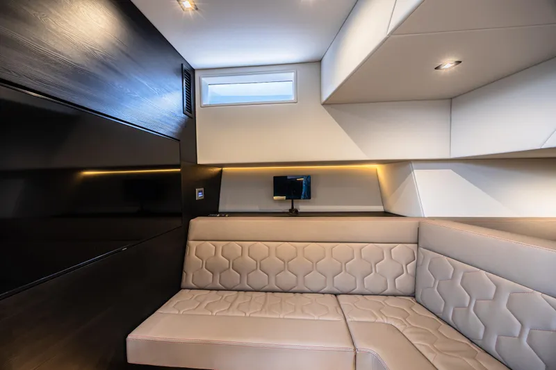 Moonshot Yacht Photos Pics Luxurious interior of 2023 Vanquish Yachts VQ58 with modern seating and ambient lighting.