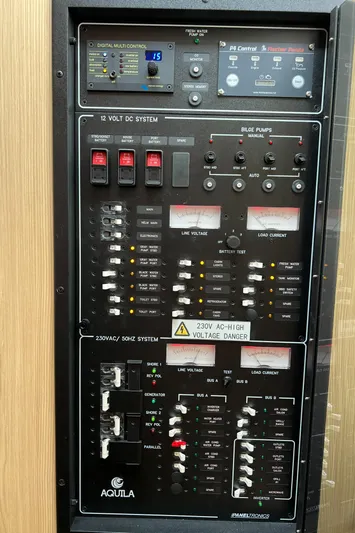  Yacht Photos Pics Control panel of a 2021 Aquila 36 Sport boat, featuring electrical and pump systems.