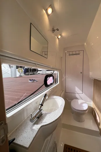  Yacht Photos Pics Modern bathroom interior of 2021 Aquila 36 Sport yacht with sleek fixtures and natural lighting.