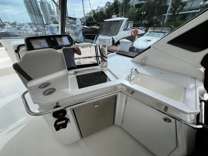  Yacht Photos Pics Interior of 2021 Aquila 36 Sport yacht with modern kitchen and navigation equipment.