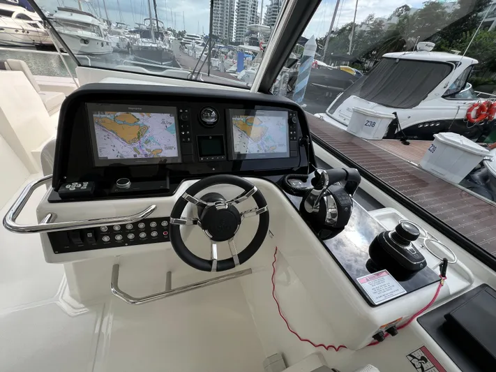  Yacht Photos Pics Helm of 2021 Aquila 36 Sport with navigation screens and controls at marina.