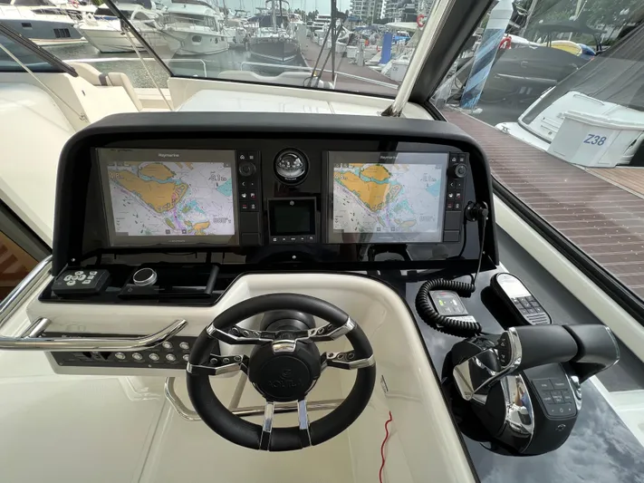  Yacht Photos Pics Helm of 2021 Aquila 36 Sport with dual navigation screens and controls.