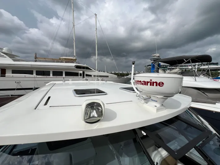  Yacht Photos Pics Aquila 36 Sport 2021 yacht with radar, docked under cloudy skies.