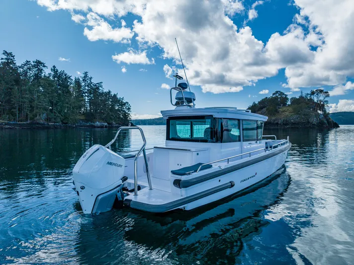 Windermere Yacht Photos Pics 2022 Axopar 28 boat on serene water with scenic forested background.