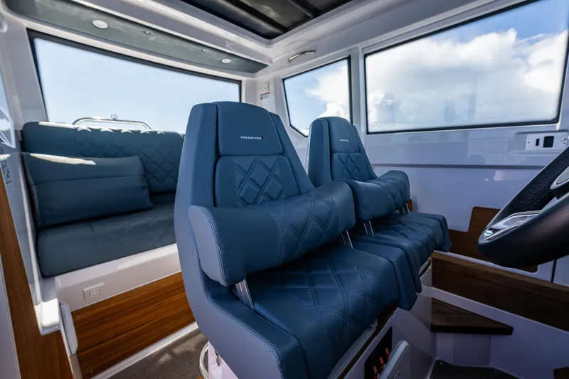 Windermere Yacht Photos Pics Interior of 2022 Axopar 28 boat with blue leather seating and modern design.