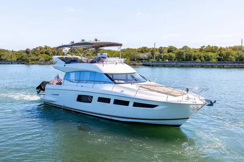  Yacht Photos Pics 2012 Prestige 500 Fly yacht cruising on a sunny day, featuring sleek design and spacious flybridge.