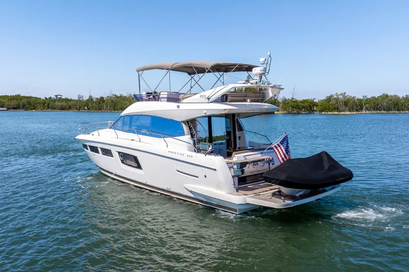  Yacht Photos Pics 2012 Prestige 500 Fly yacht cruising on a serene lake with clear blue skies.