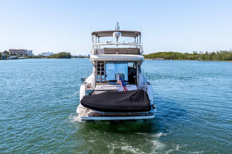  Yacht Photos Pics 2012 Prestige 500 Fly yacht cruising on a serene waterway.