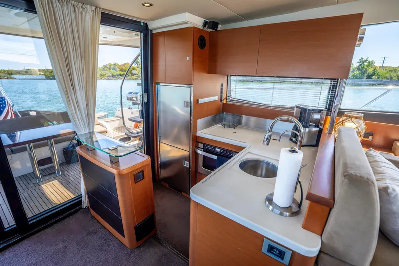  Yacht Photos Pics Luxurious interior of 2012 Prestige 500 Fly yacht with modern kitchen and scenic water view.