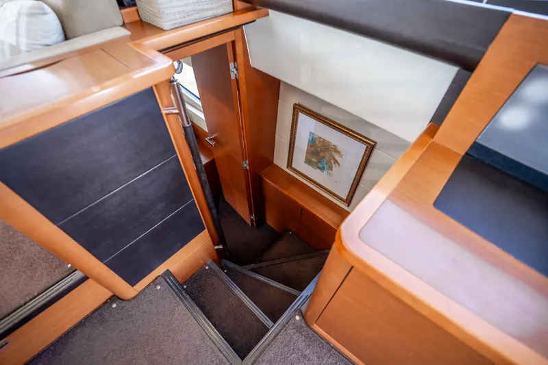  Yacht Photos Pics Interior stairs of 2012 Prestige 500 Fly yacht, featuring wood finish and framed artwork.