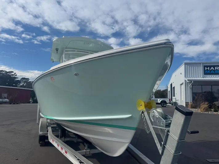  Yacht Photos Pics 2023 Albury Brothers 27 boat on trailer under a partly cloudy sky.