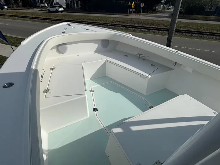  Yacht Photos Pics 2023 Albury Brothers 27 boat interior, showcasing spacious white deck and storage compartments.