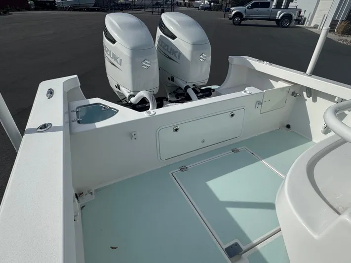  Yacht Photos Pics 2023 Albury Brothers 27 boat with dual Suzuki outboard engines, docked on a sunny day.