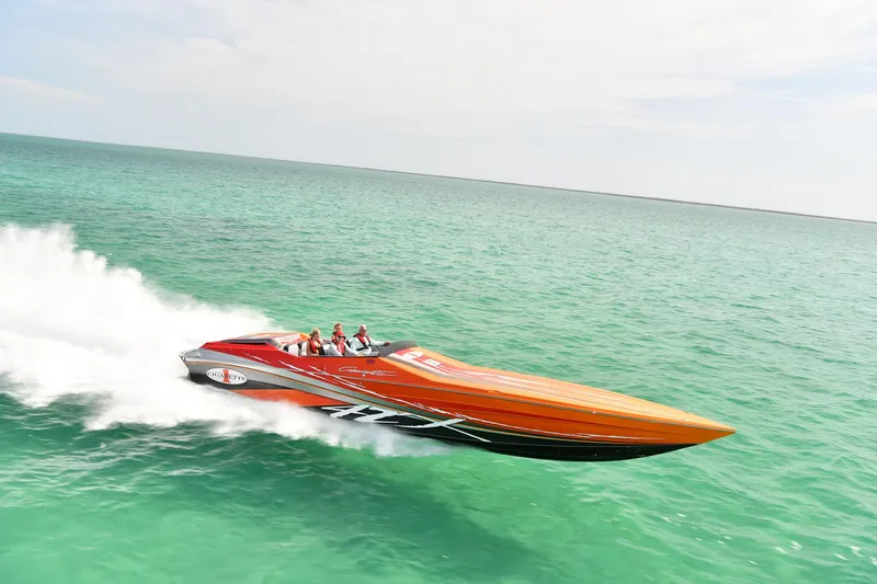  Yacht Photos Pics 2014 Cigarette 42X speedboat cruising on turquoise ocean waters.