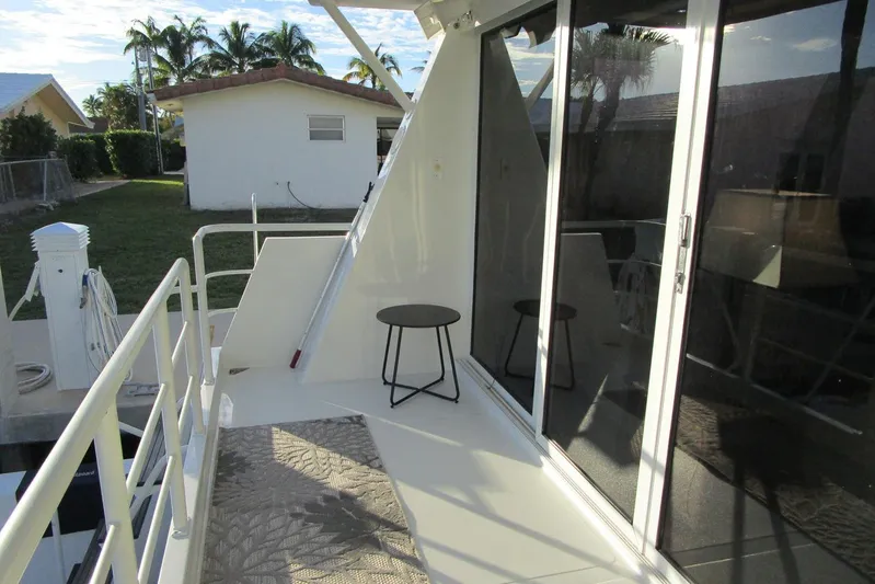 Lucky Stars Yacht Photos Pics 1990 Viking 72 Cockpit Motor Yacht deck with seating, railing, and sliding glass doors.