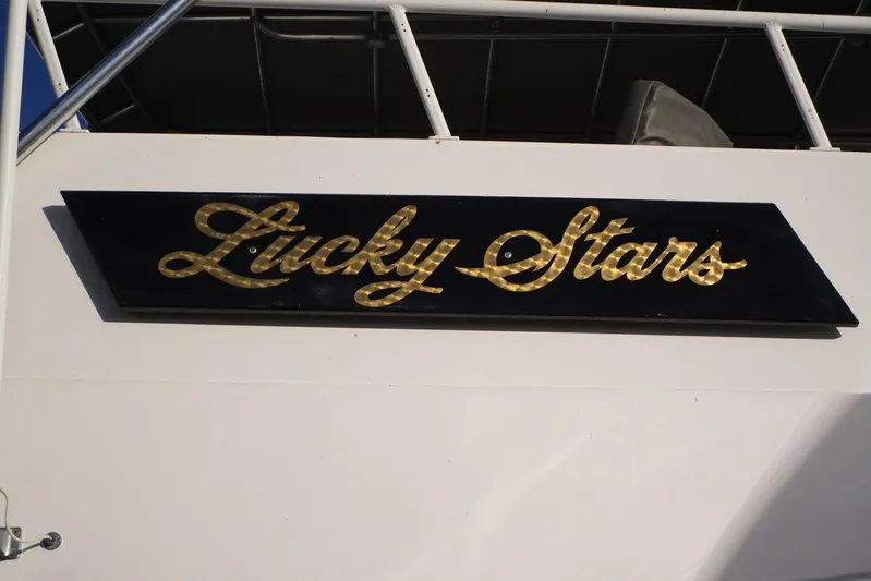 Lucky Stars Yacht Photos Pics Gold "Lucky Stars" sign on 1990 Viking 72 Cockpit Motor Yacht.