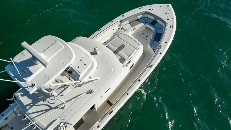  Yacht Photos Pics 2020 Pursuit S 408 Sport boat on clear blue water, aerial view.