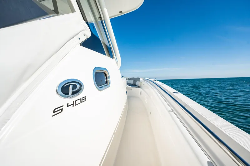  Yacht Photos Pics 2020 Pursuit S 408 Sport boat on open sea under clear blue sky.
