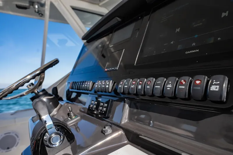  Yacht Photos Pics 2020 Pursuit S 408 Sport boat dashboard with controls and steering wheel.
