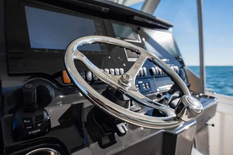  Yacht Photos Pics Steering wheel and controls of 2020 Pursuit S 408 Sport boat, ocean view.