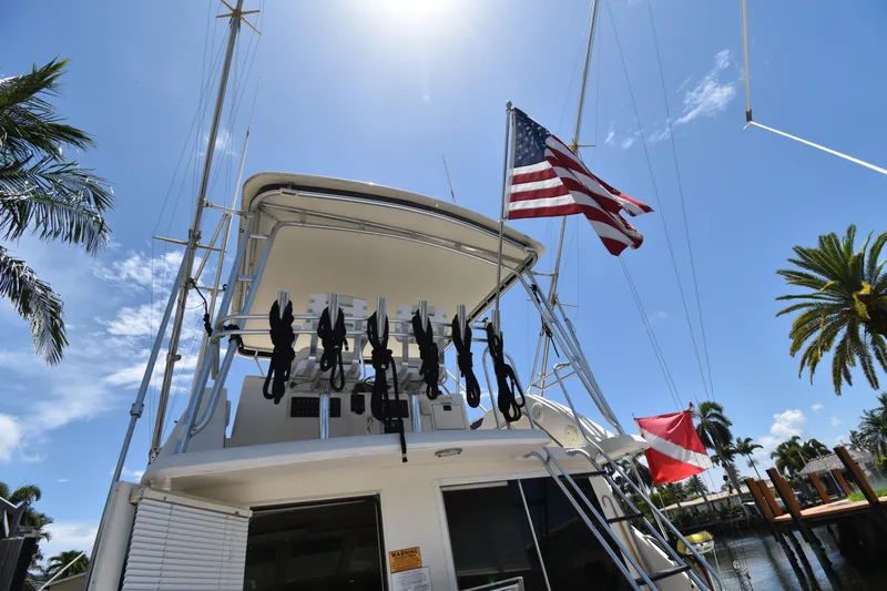  Yacht Photos Pics 1997 Tiara 4300 yacht with American flag, docked under sunny skies and palm trees.